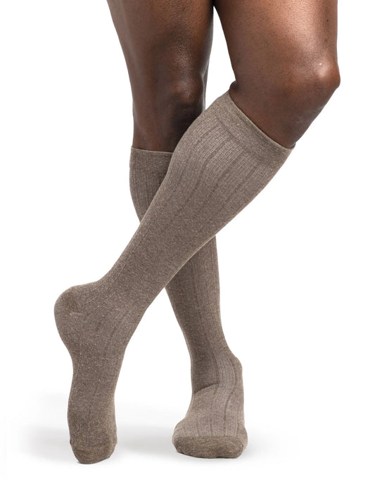 Legs of model in Sigvaris Linen compression calf socks in brown.