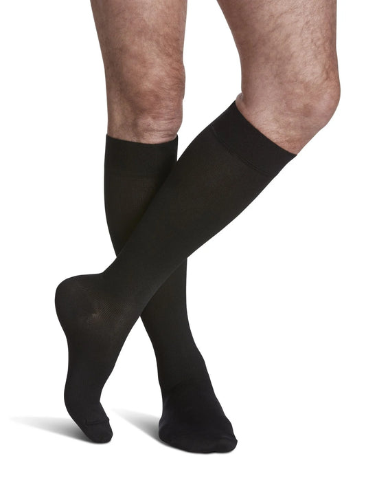 Legs of model in Sigvaris Men's Microfiber compression calf socks in black.