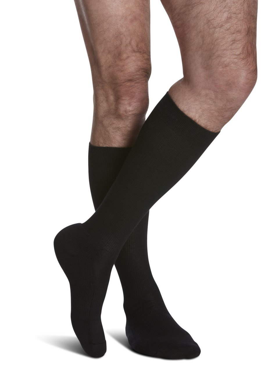 Legs of male model in knee-length Sigvaris Cushioned Cotton compression calf socks in black.