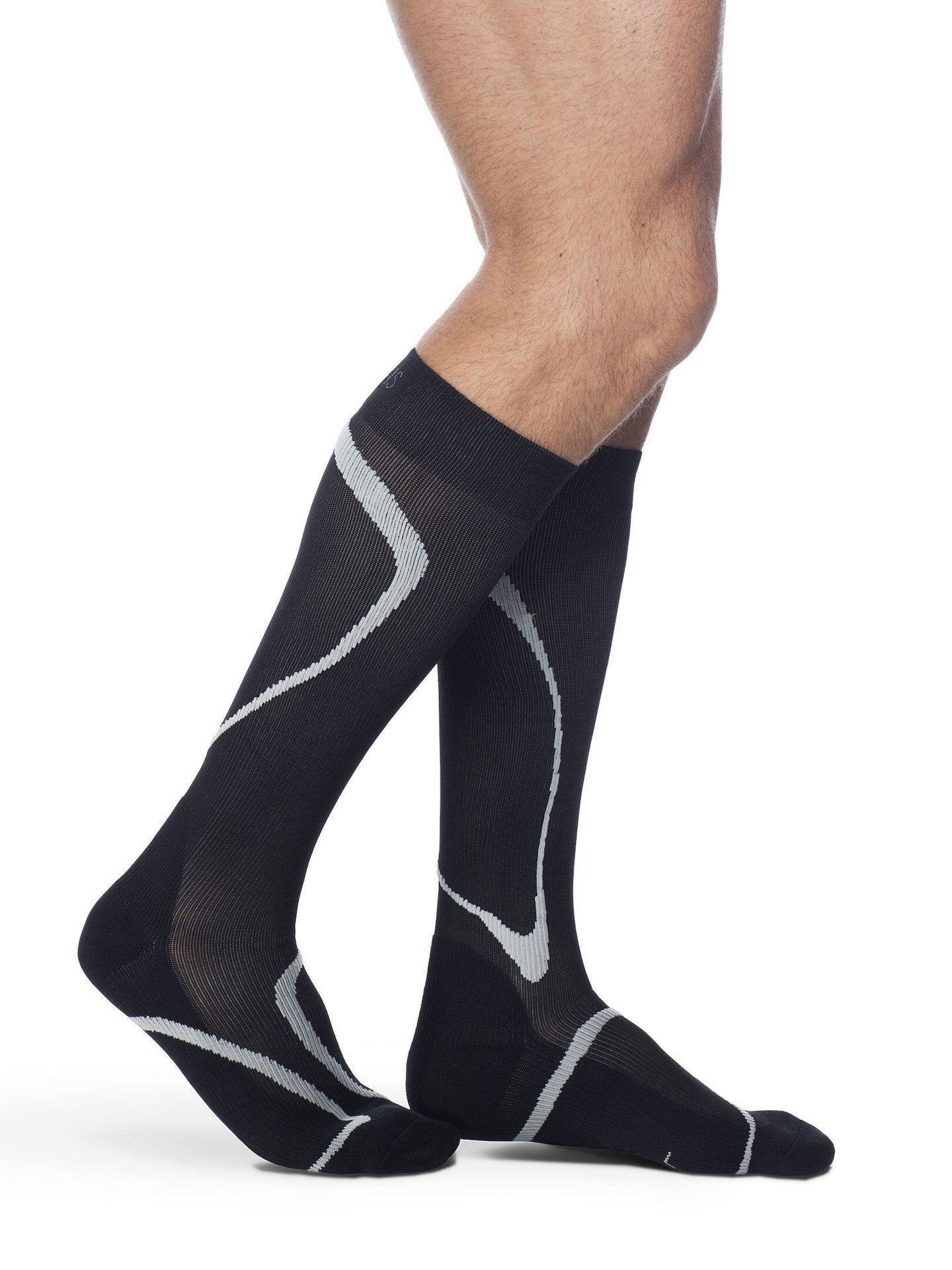 Legs of male model wearing Sigvaris High Tech compression calf socks in black.