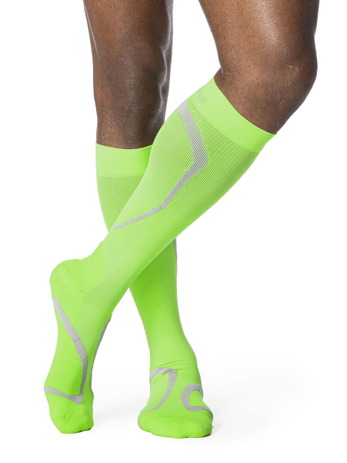 Legs of male model wearing Sigvaris High Tech compression calf socks in lime.