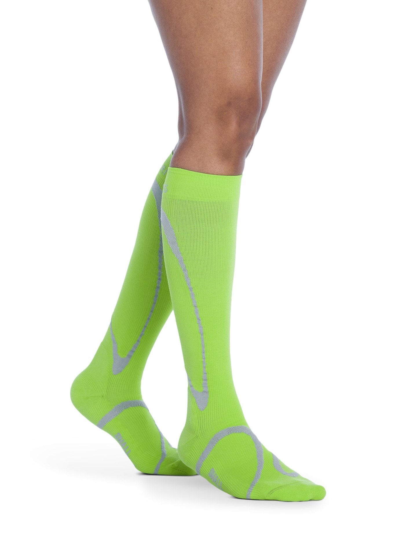 Legs of female model wearing Sigvaris High Tech compression calf socks in lime.