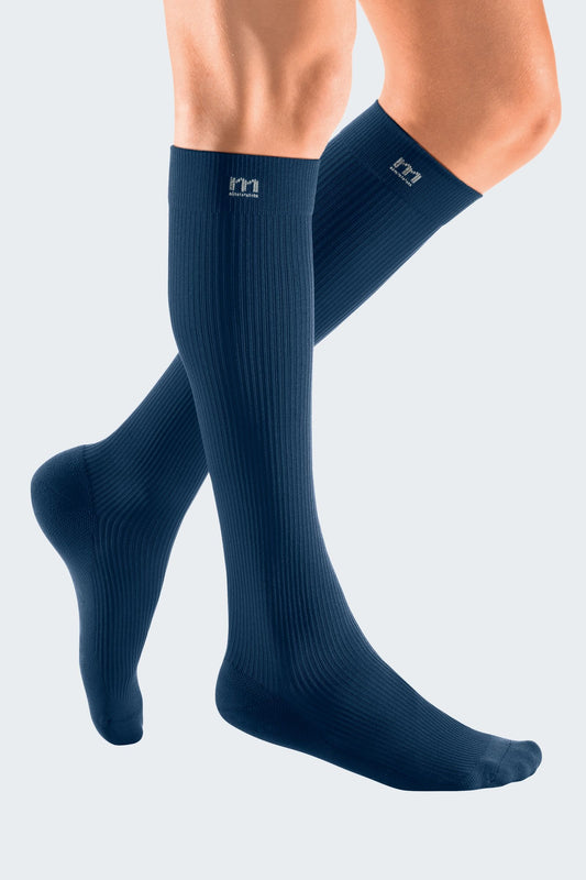 Lower legs of model in Mediven Active compression socks in navy.