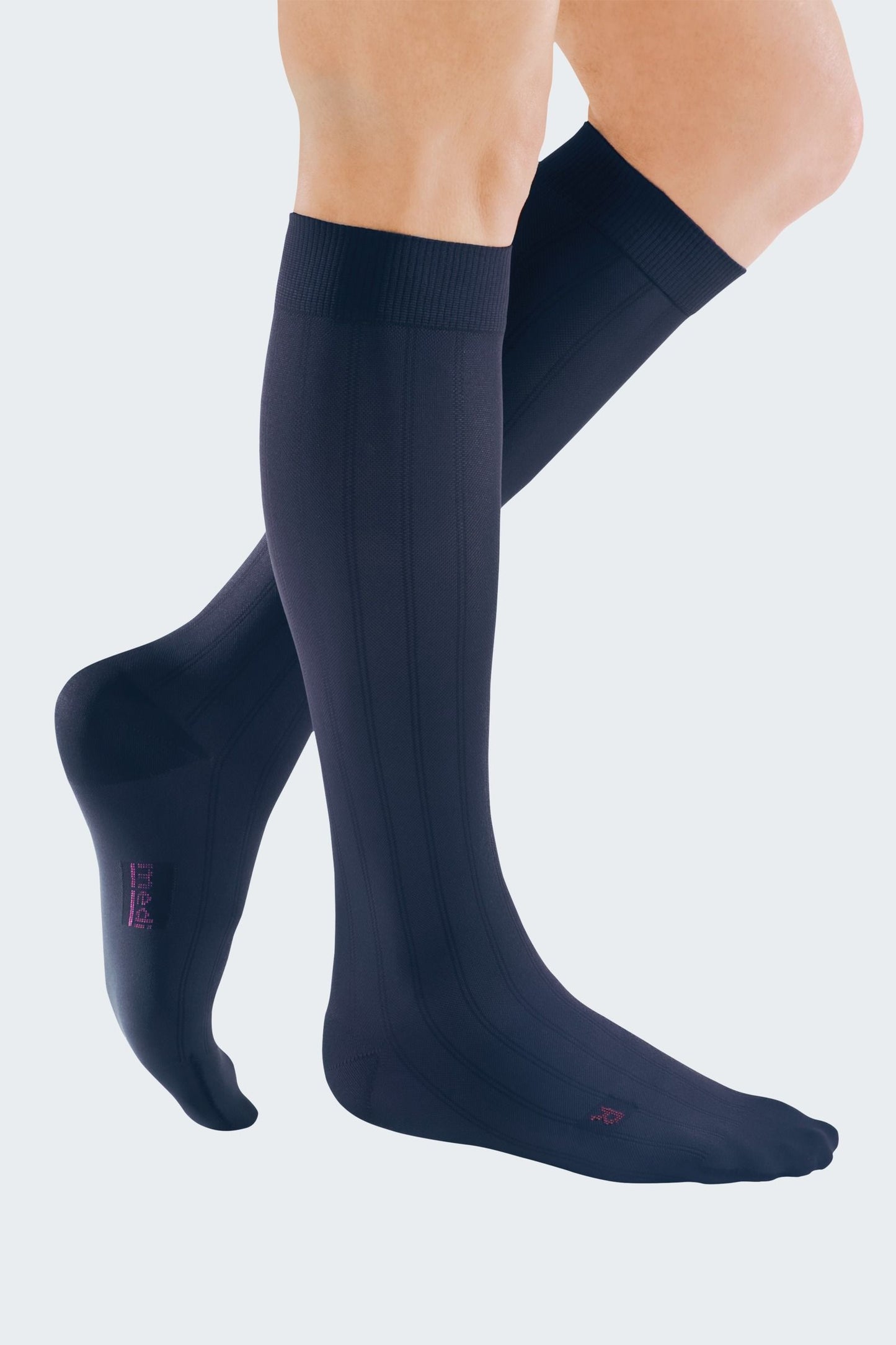 Lower legs of model in knee-high Mediven Men's dress compression socks in navy.