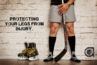 Lower body of ice hockey player in Lunatik Vibe Tech compression socks in black, with the words "Protecting your legs from injury."