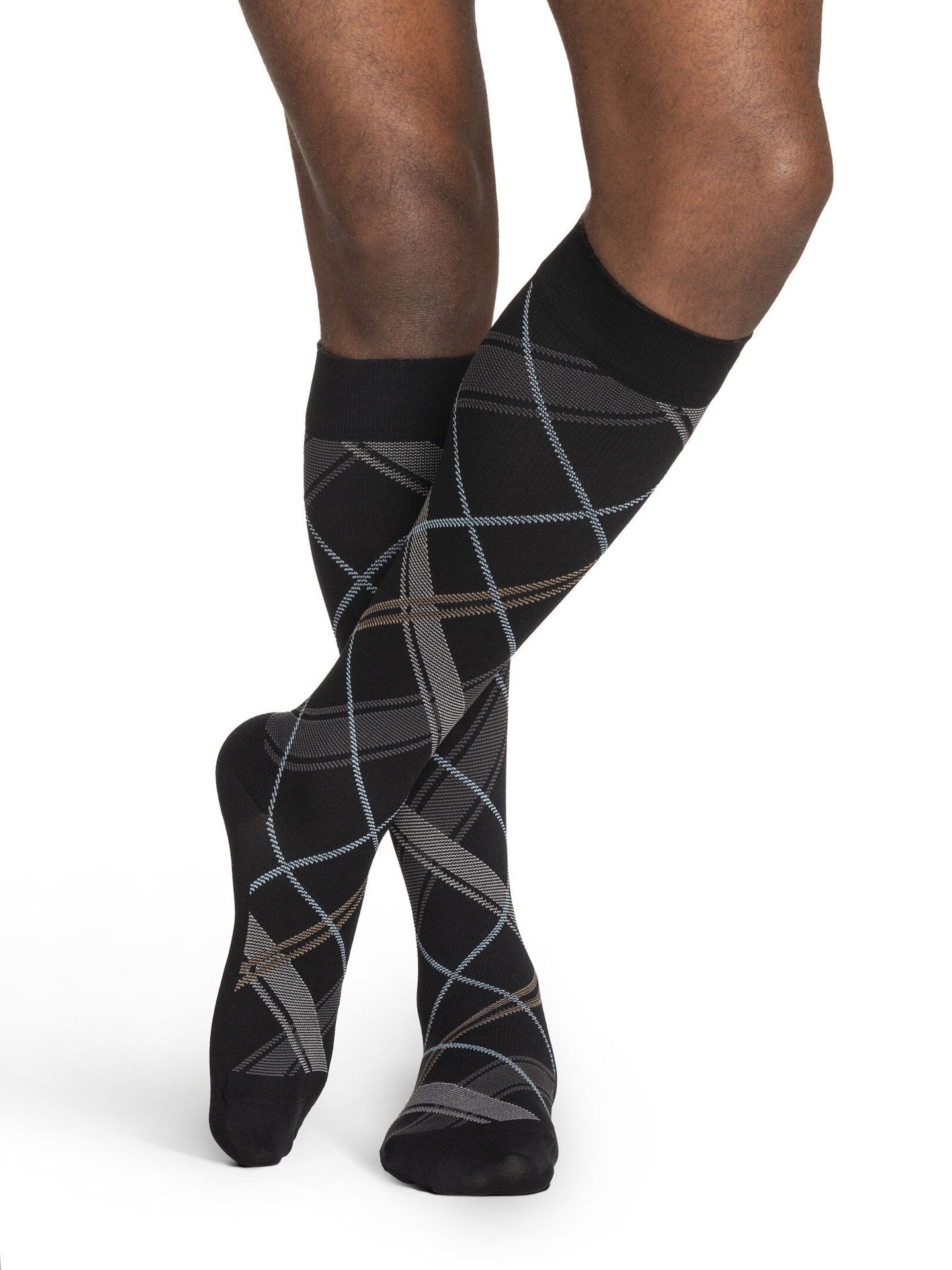 Legs of male model in Sigvaris Microfiber Patterns compression socks in black plaid.