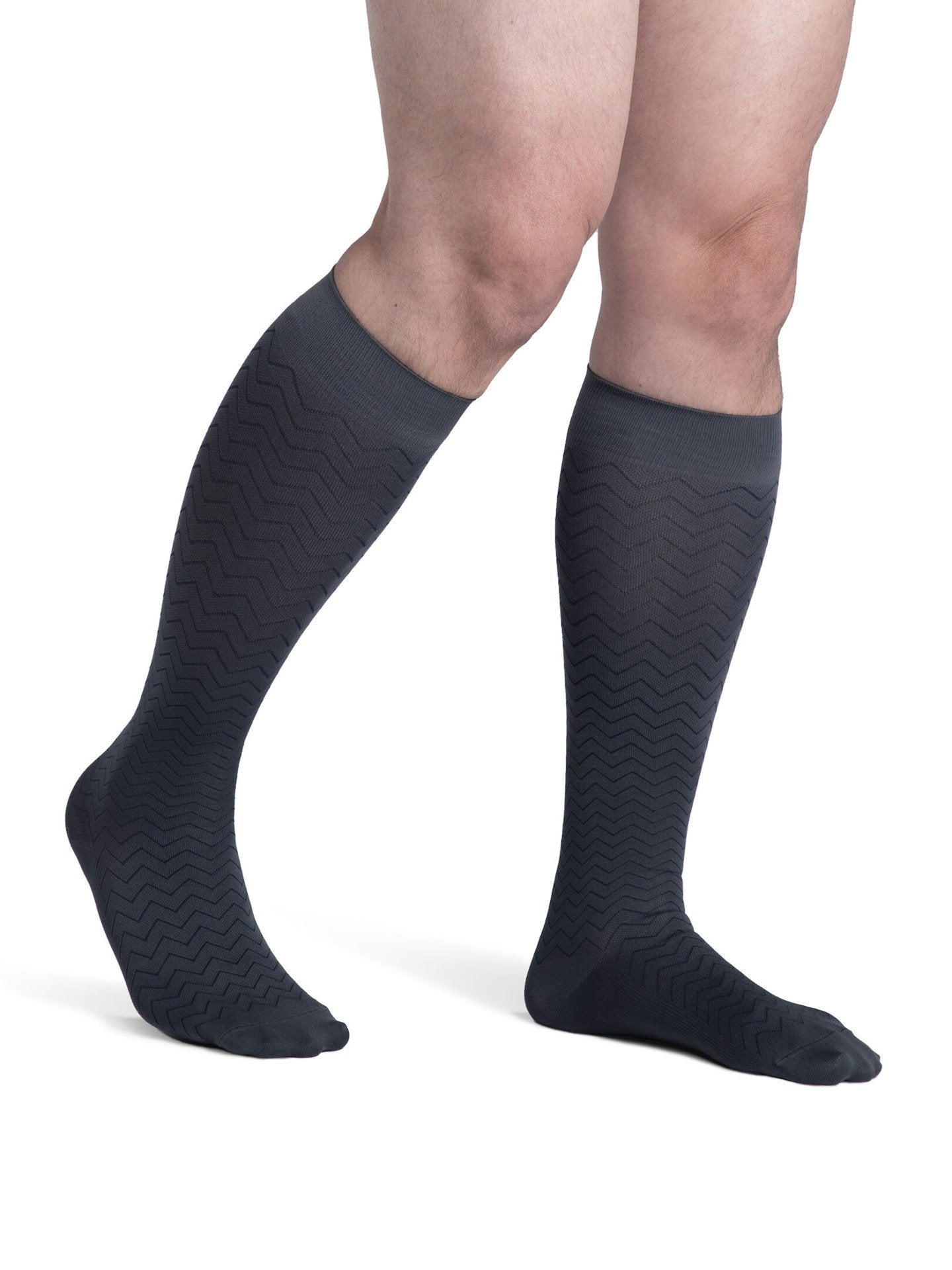 Legs of male model in Sigvaris Microfiber Patterns compression socks in graphite chevron.