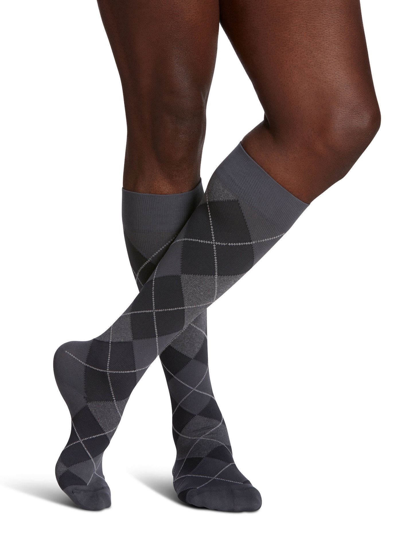 Legs of male model in Sigvaris Microfiber Patterns compression socks in graphite argyle.