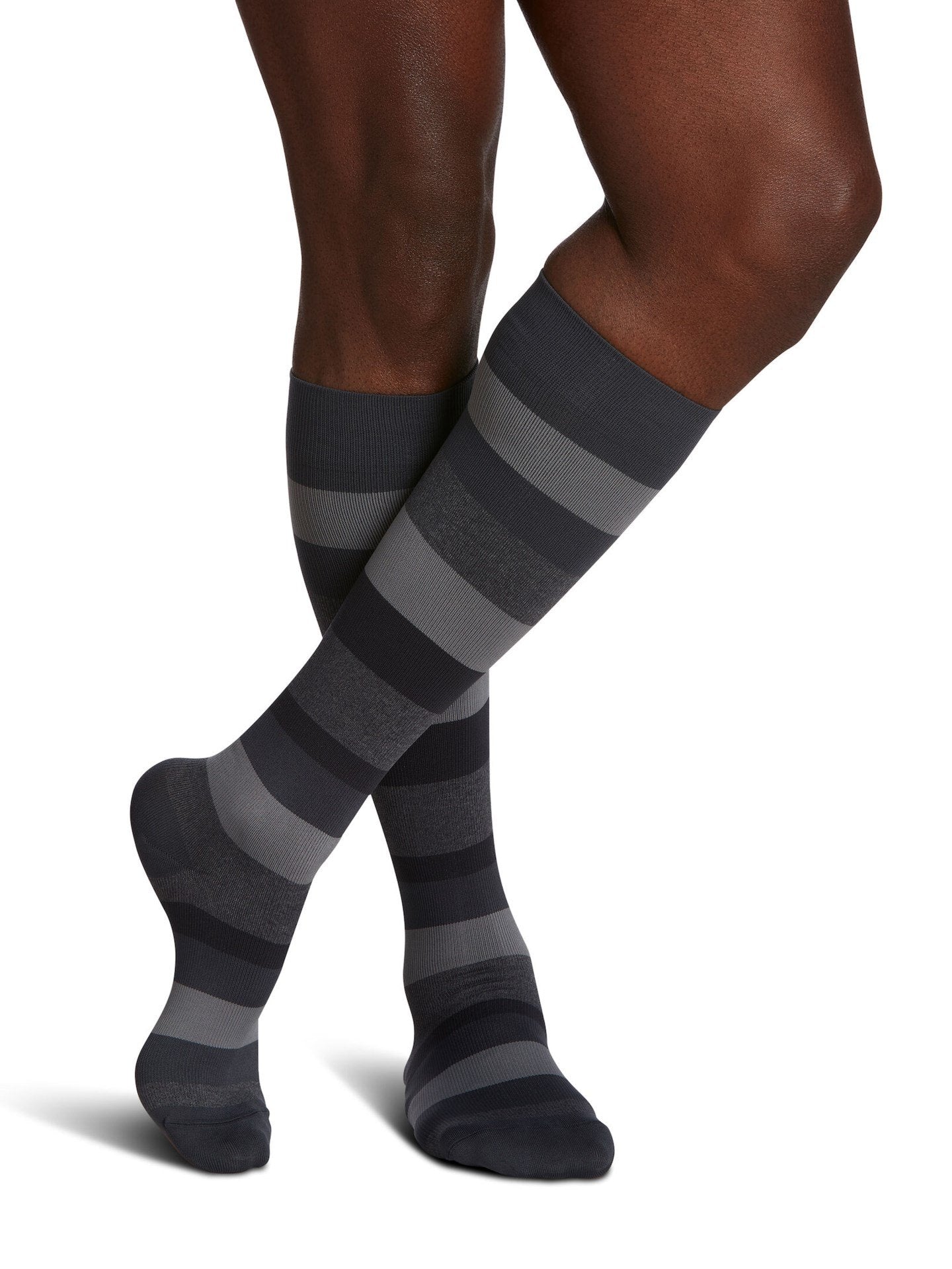 Legs of male model in Sigvaris Microfiber Patterns compression socks in graphite stripe.