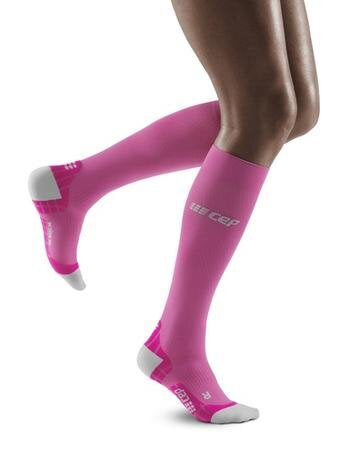 Lower legs of model in knee-high CEP Ultralight Running compression socks in pink, with white toes and heels.