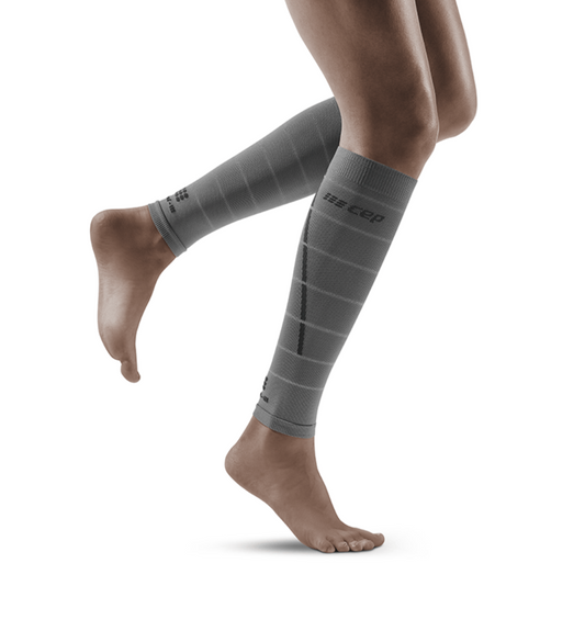 Lower legs of female model in CEP Reflective compression calf sleeves in grey.