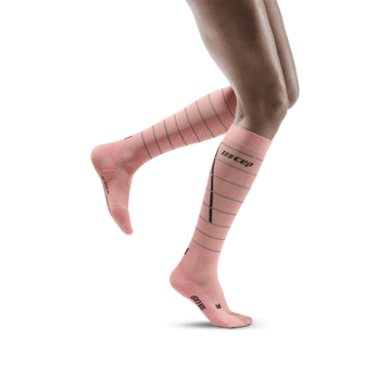 Lower legs of model in knee-high CEP Reflective running compression socks in pink.