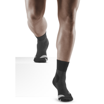 Lower legs of model in CEP Merino Wool compression socks in black.