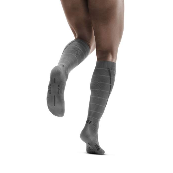 Lower legs of model in CEP Reflective compression socks in grey (back view).