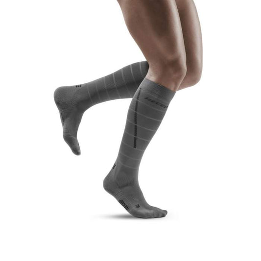 Lower legs of model in CEP Reflective compression socks in grey (side view).