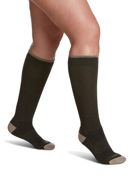 Legs of female model in Sigvaris Thermoregulating Wool compression socks in olive.