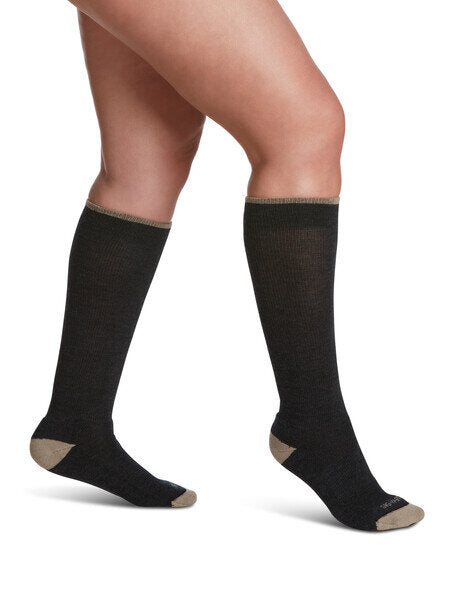 Legs of female model in Sigvaris Thermoregulating Wool compression socks in charcoal.