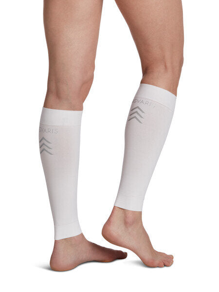 Legs of model in white Sigvaris Calf Performance compression sleeves on white background.